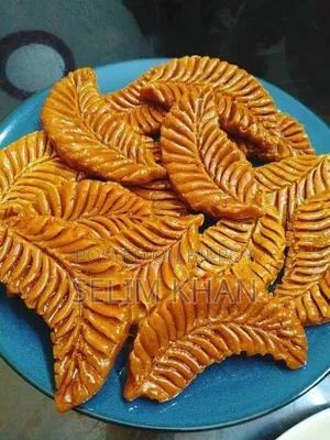 Nakshi Pitha and Jhinuk Pitha soaked in molasses syrup