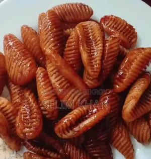 Nakshi Pitha and Jhinuk Pitha soaked in molasses syrup