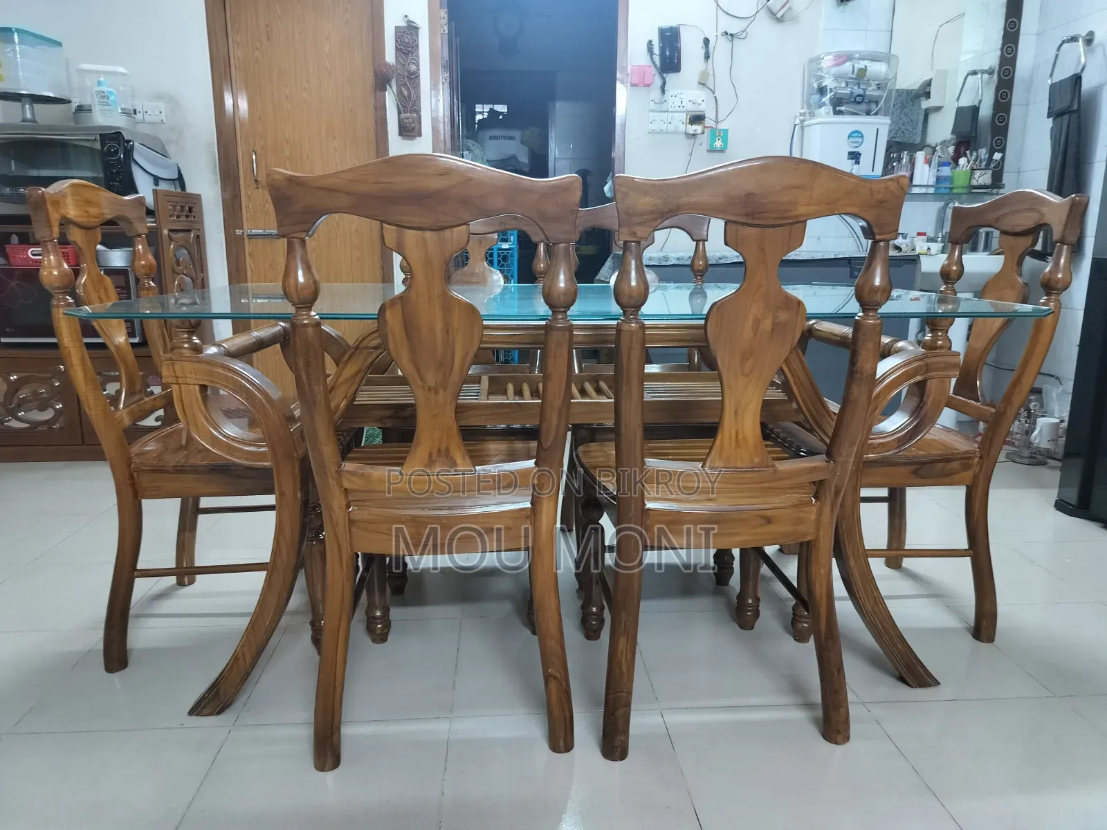 Teak wood 6-chair dining table.