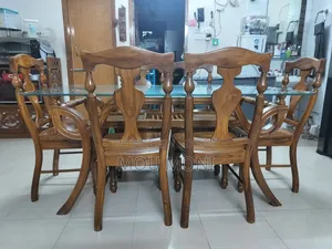 Teak wood 6-chair dining table.