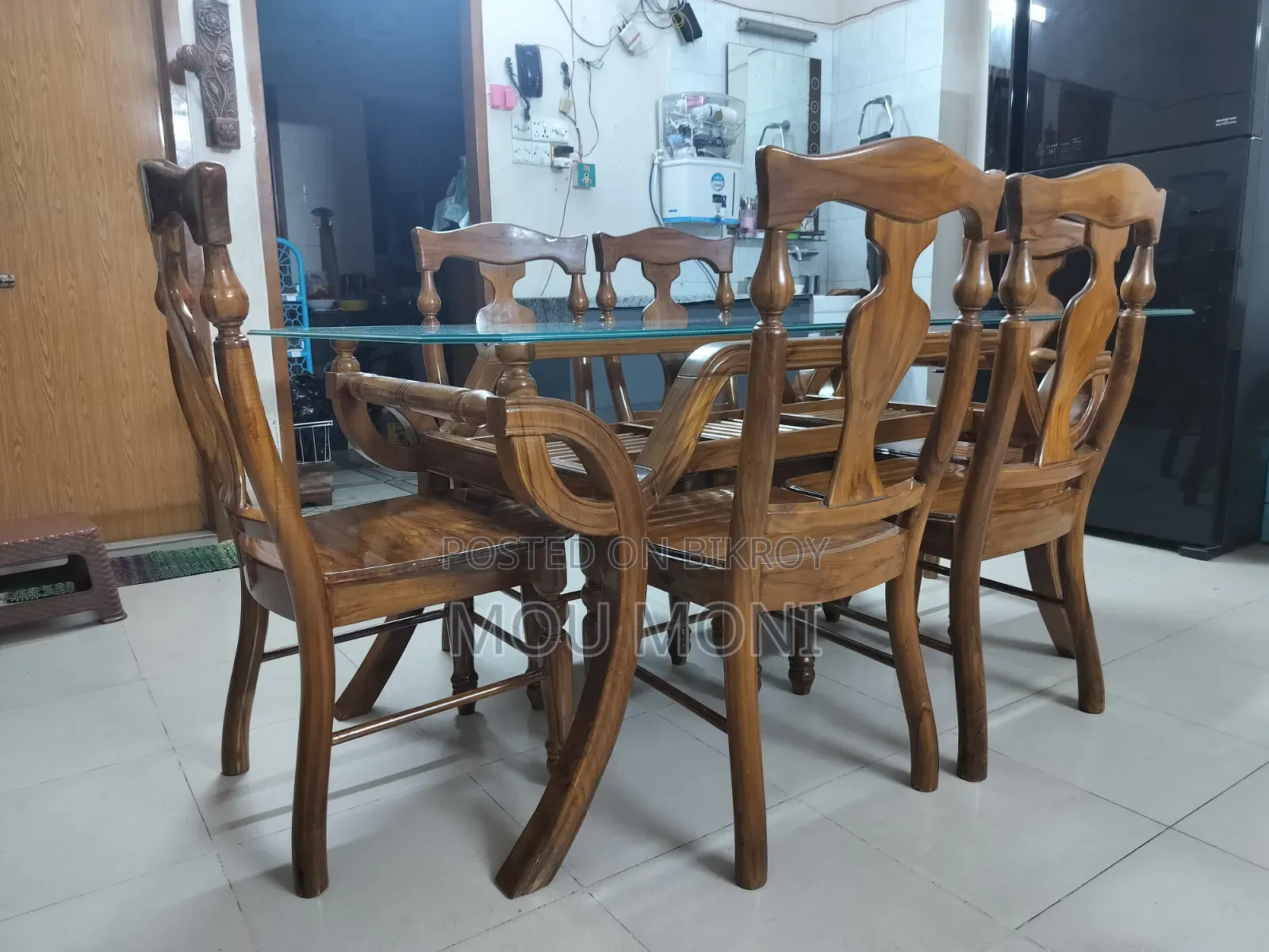 Teak wood 6-chair dining table.