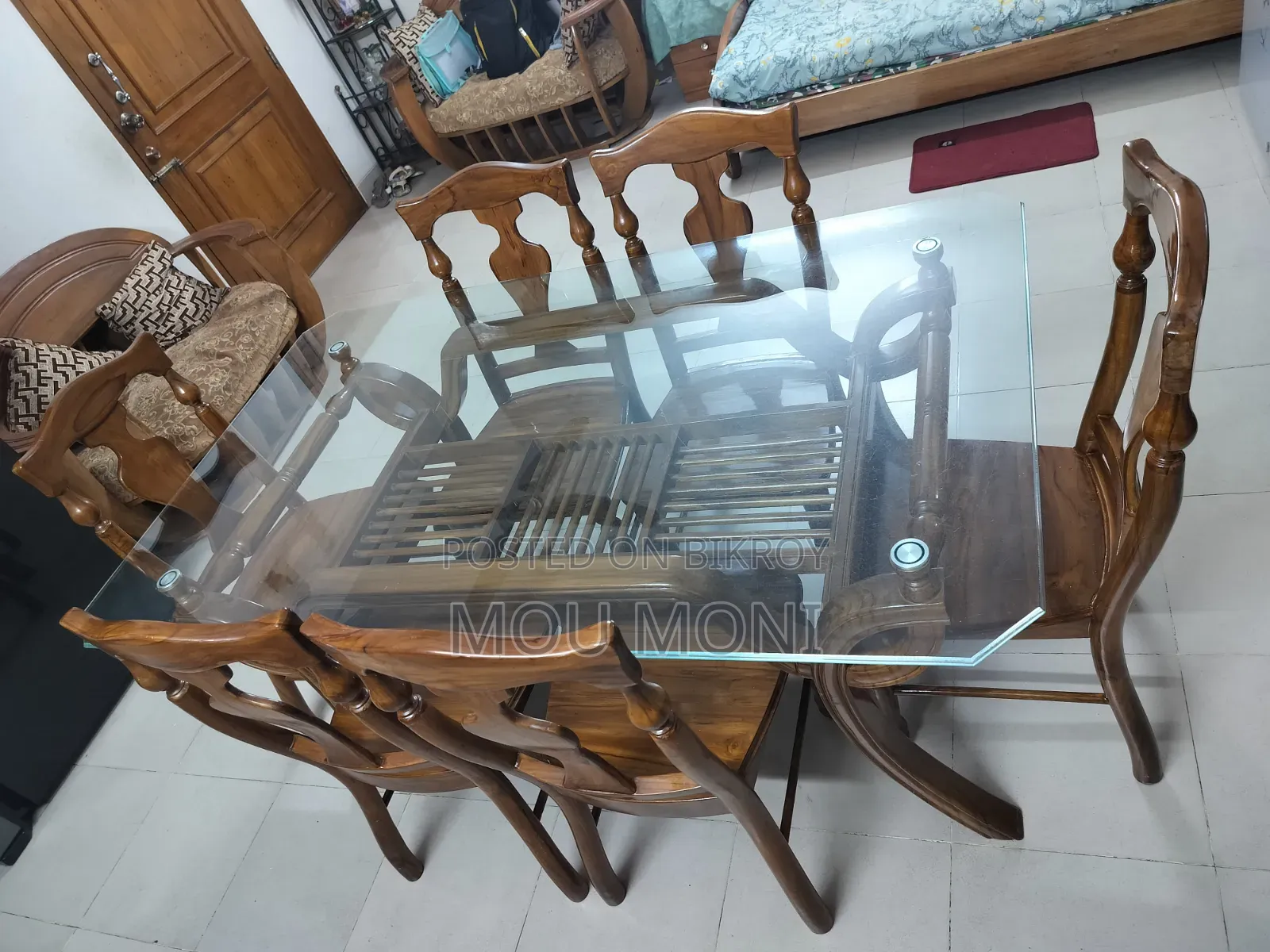 Teak wood 6-chair dining table.