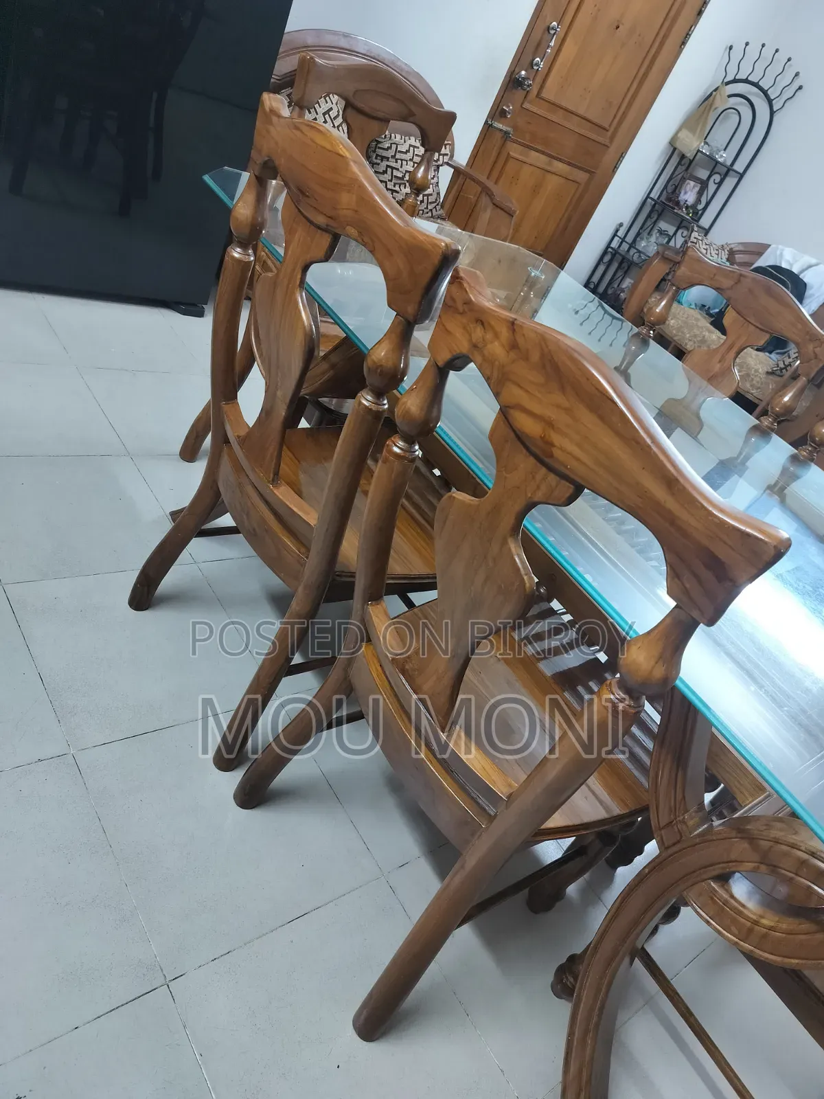 Teak wood 6-chair dining table.