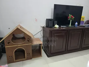A wooden cat house for sale.