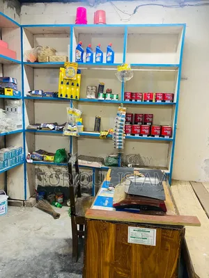 Shop wooden shelves and shop goods for sale.