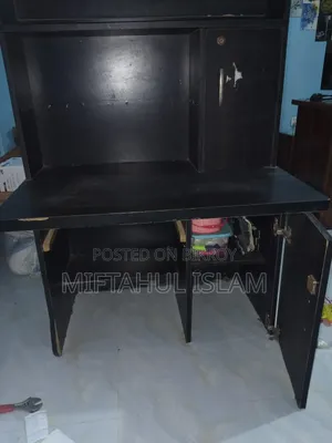 A double bed frame and a computer table for sale
