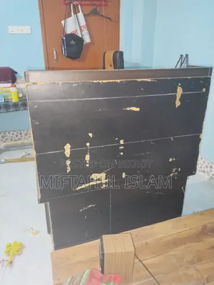 A double bed frame and a computer table for sale