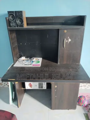 A double bed frame and a computer table for sale