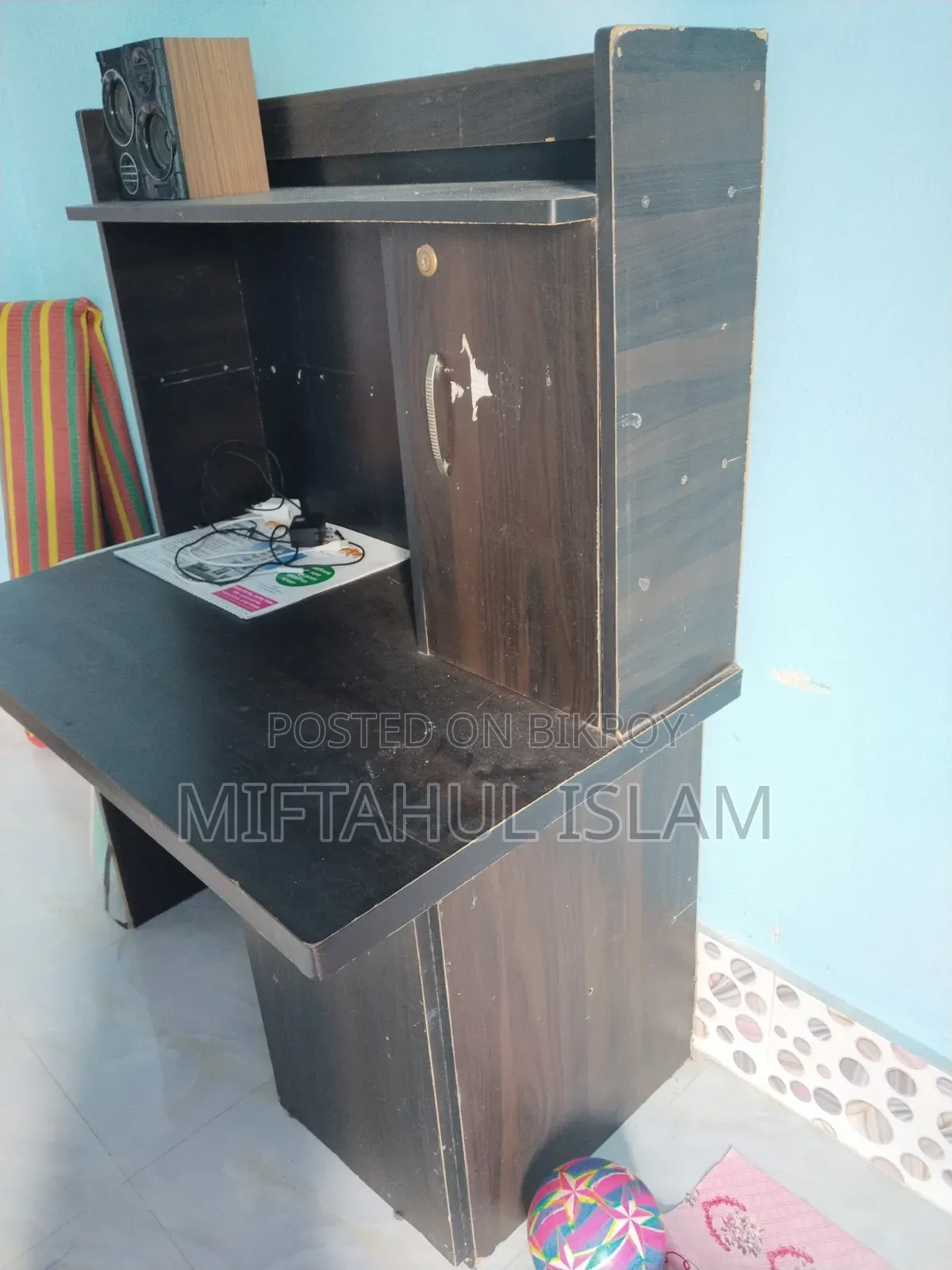 A double bed frame and a computer table for sale