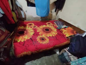 A used teak wood bed