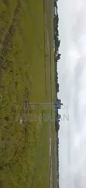 Land with a big road nearby, mosque, madrasa, and shops in the vicinity