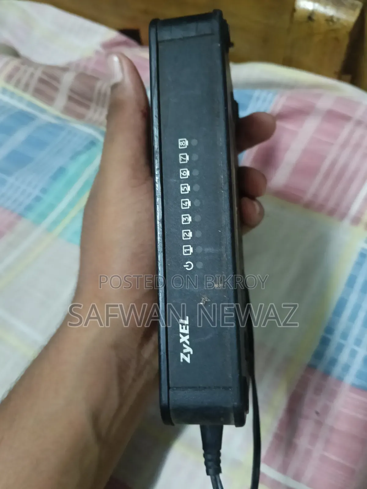 The device marked in the picture is a ZyXEL ES-108E network switch.