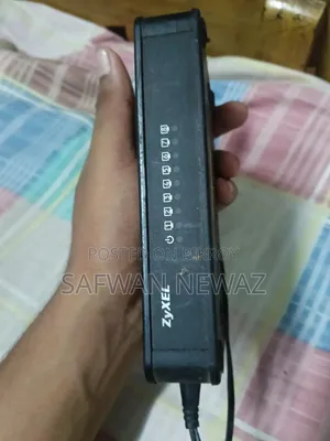 The device marked in the picture is a ZyXEL ES-108E network switch.