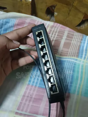The device marked in the picture is a ZyXEL ES-108E network switch.