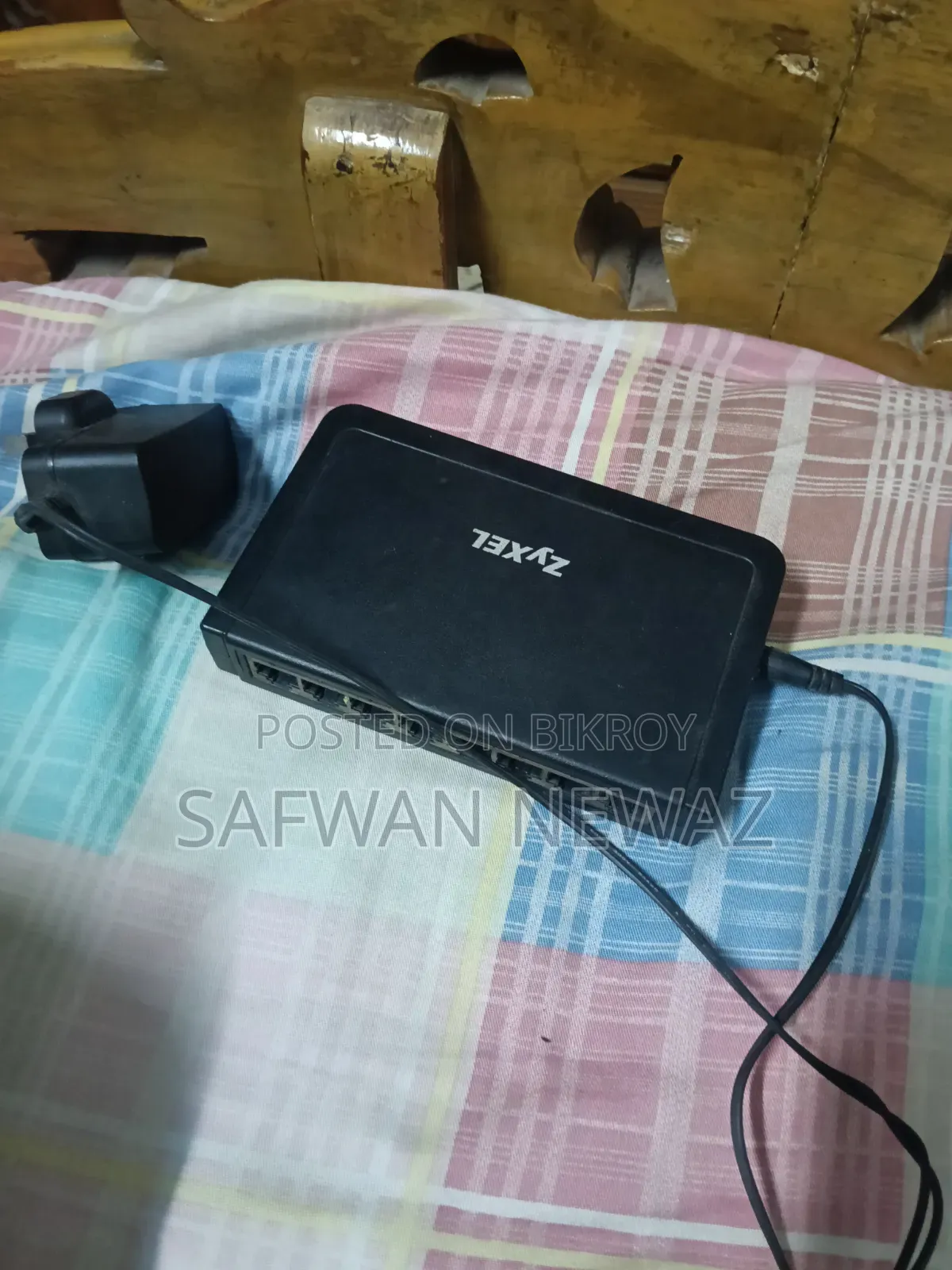 The device marked in the picture is a ZyXEL ES-108E network switch.