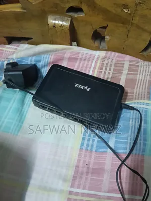 The device marked in the picture is a ZyXEL ES-108E network switch.