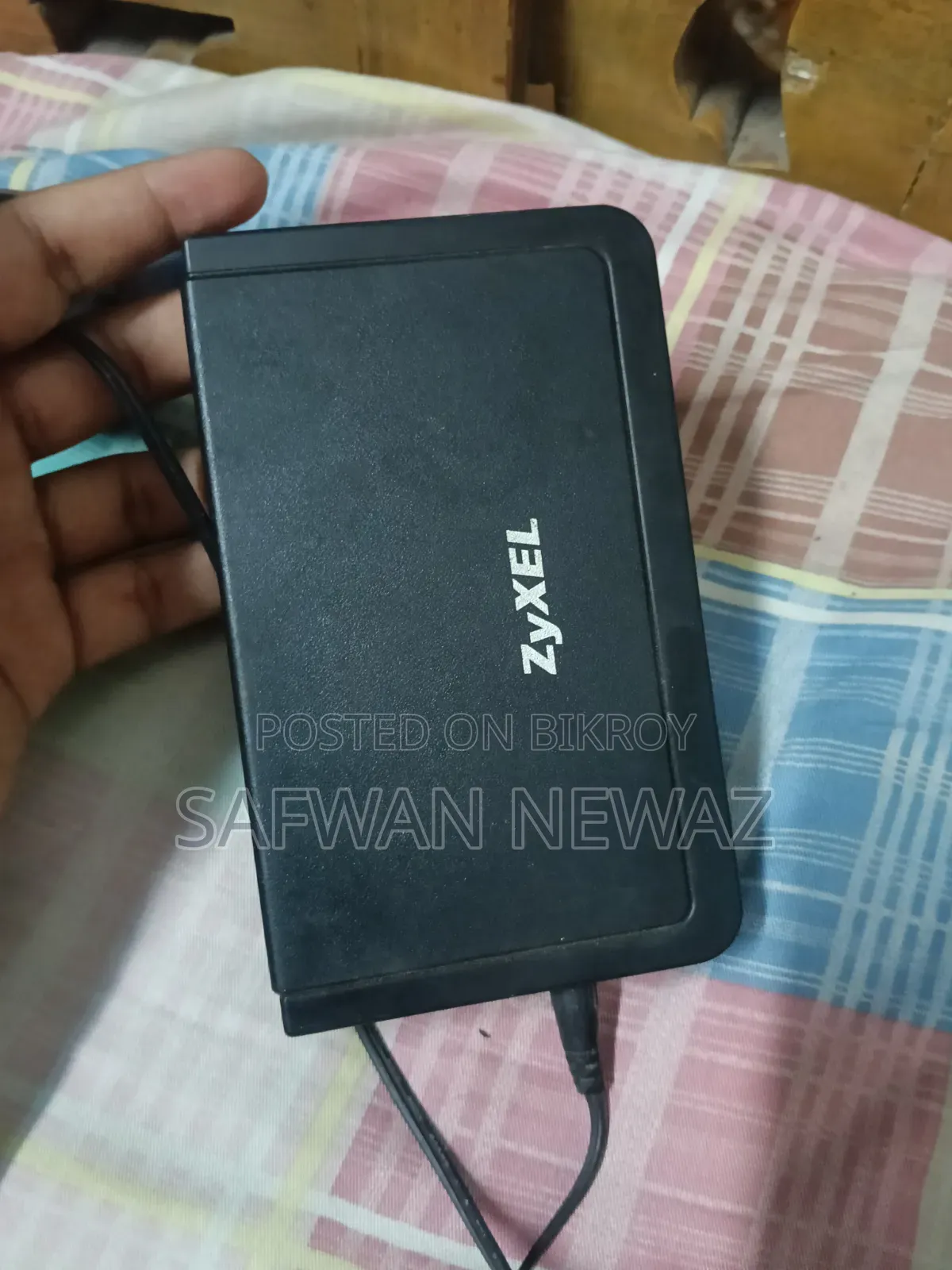 The device marked in the picture is a ZyXEL ES-108E network switch.