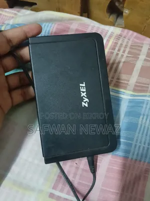 The device marked in the picture is a ZyXEL ES-108E network switch.