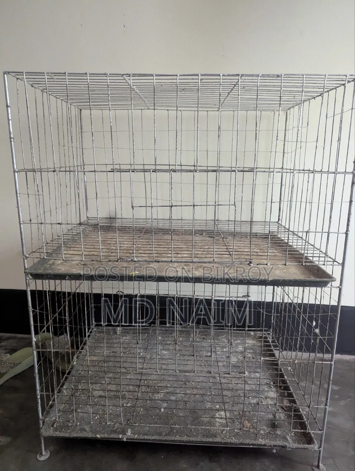 A 2-story thick wire pigeon cage