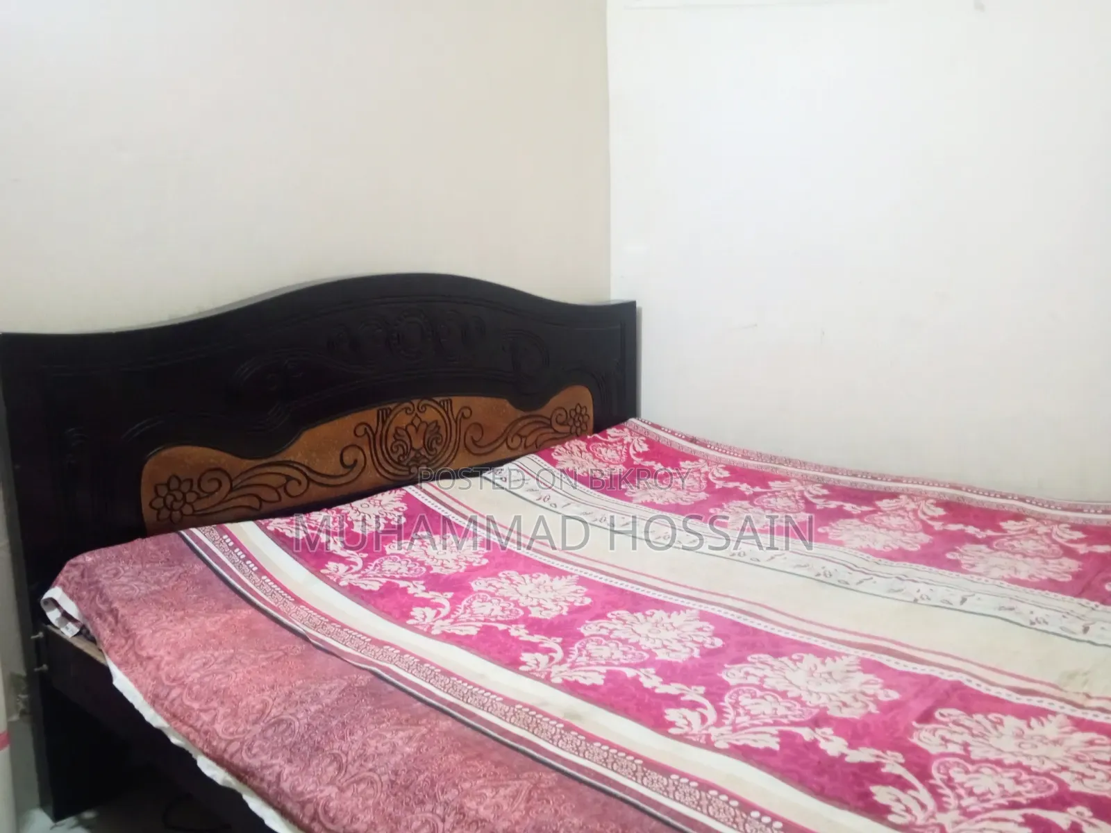 Wooden bed cot. Length and width are 6 feet by 7 feet.