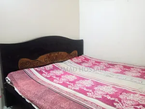 Wooden bed cot. Length and width are 6 feet by 7 feet.