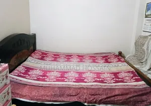 Wooden bed cot. Length and width are 6 feet by 7 feet.