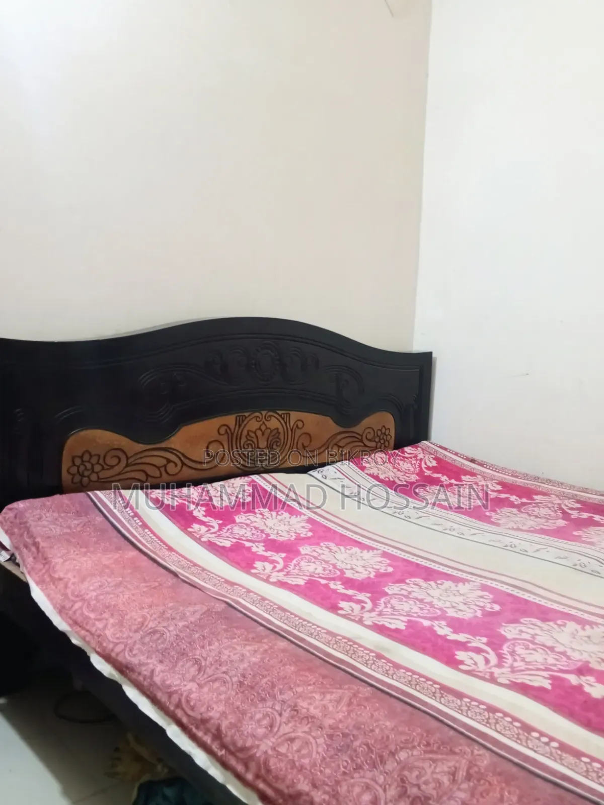 Wooden bed cot. Length and width are 6 feet by 7 feet.