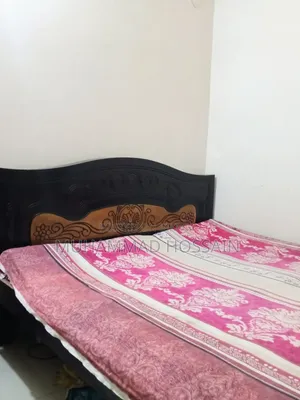 Wooden bed cot. Length and width are 6 feet by 7 feet.