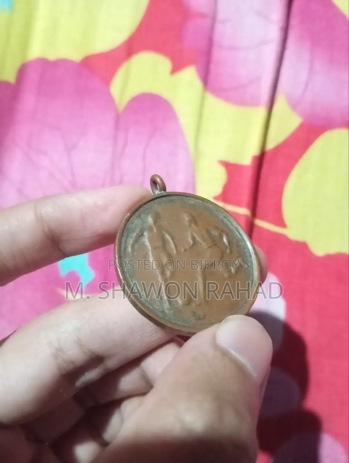 An old 19th-century metal locket/medallion