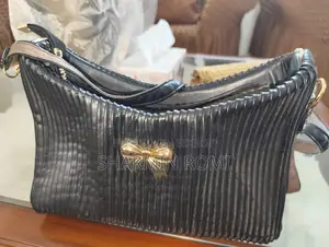 Black Pleated/Ribbed Shoulder Bag With Gold Bow Accent