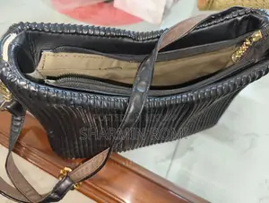 Black Pleated/Ribbed Shoulder Bag With Gold Bow Accent