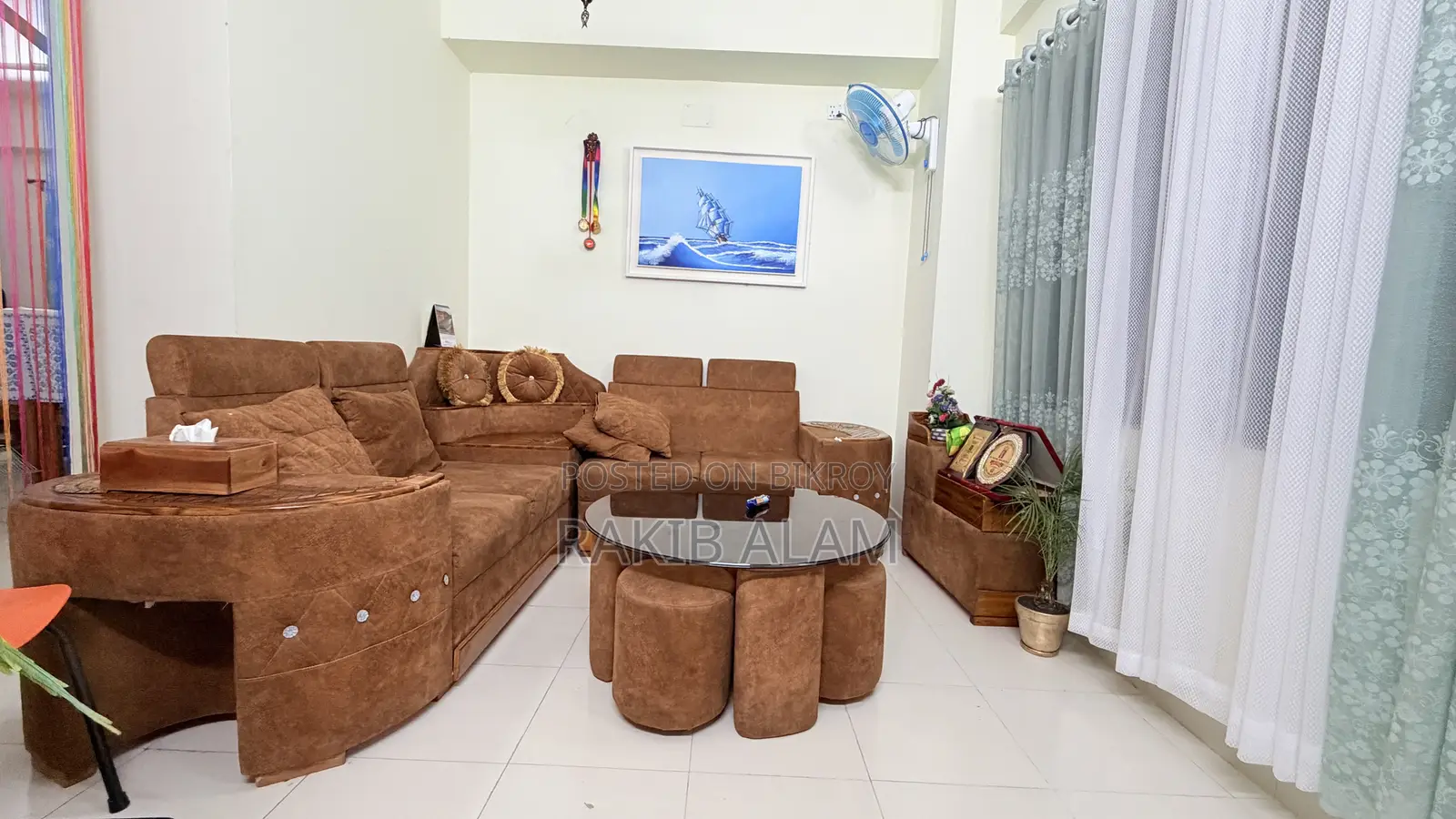 Sofa set with table and 5 stools for seating.