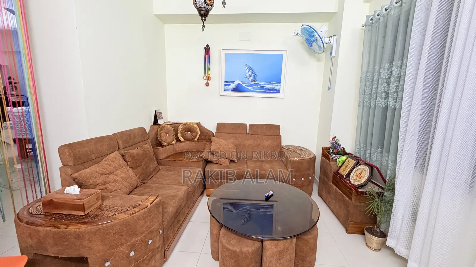 Sofa set with table and 5 stools for seating.