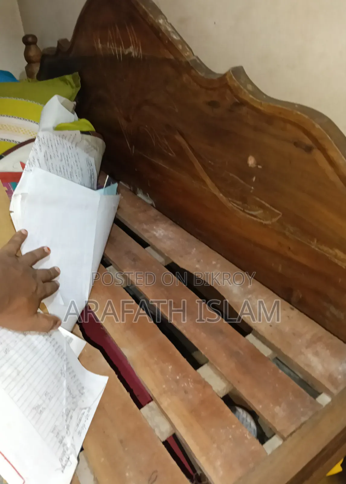 A wooden bed for three people will be sold