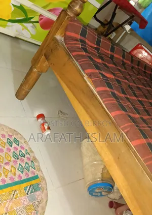 A wooden bed for three people will be sold