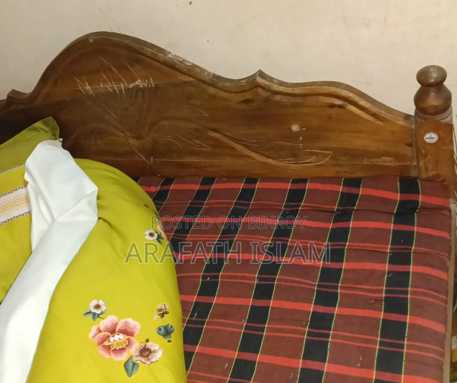 A wooden bed for three people will be sold