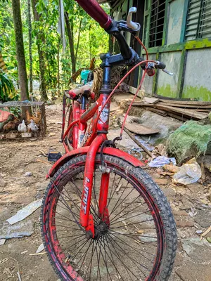 A gorgeous red children's bicycle.