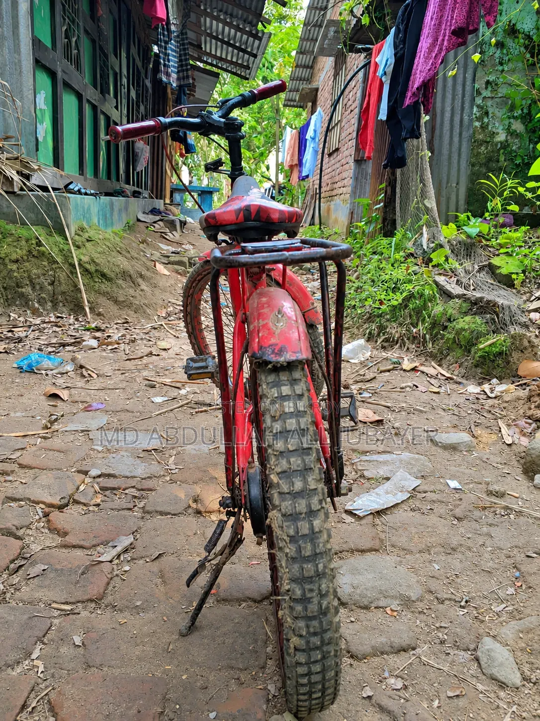 A gorgeous red children's bicycle.