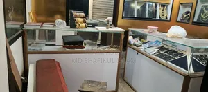 Two counters, one L-shaped, one straight, wall showcase on both sides