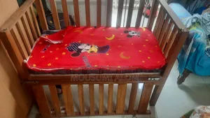 Wooden baby cot with mattress