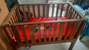 Wooden baby cot with mattress
