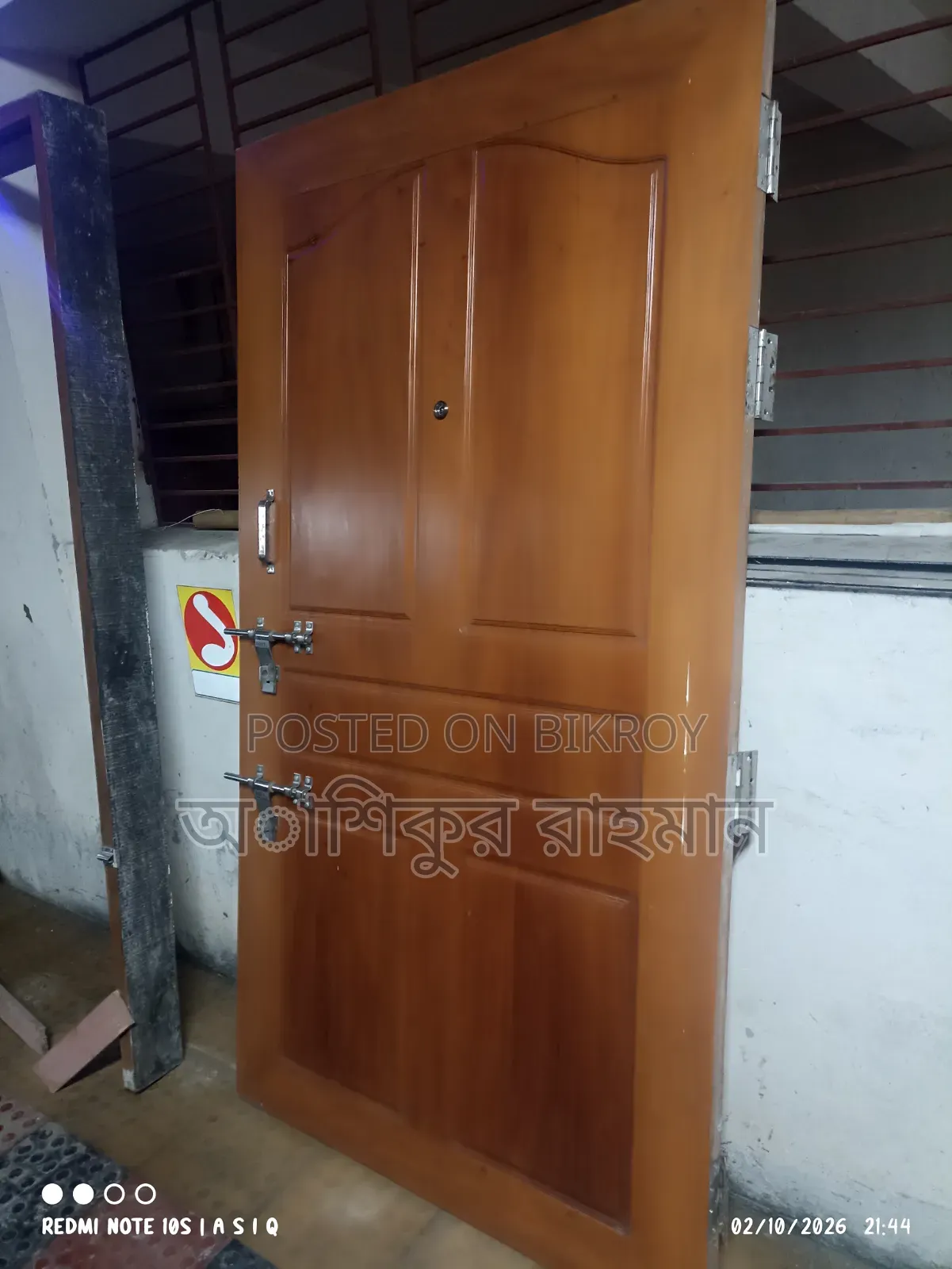 An iron wood (Ajubi) door frame and shutter will be sold with complete fittings.