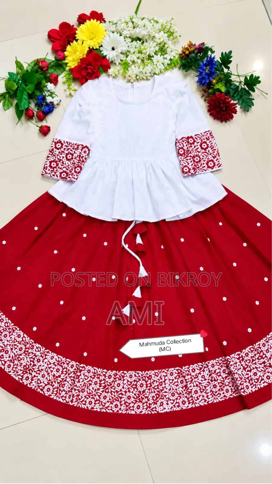 Tops and skirts made with block print on red and white cotton fabric.
